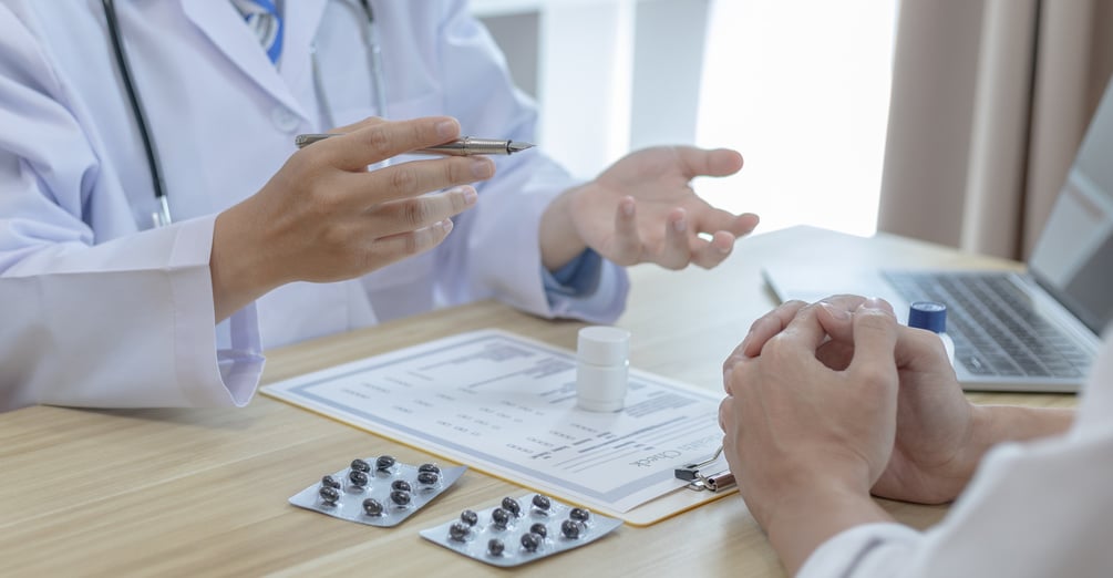 Midsection Of Doctor Counseling Patient At Clinic